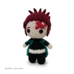 crochet doll with big black eyes and red spiky hair